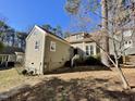 Rear view of house showcasing tan siding and landscaping at 5718 Sentinel Dr, Raleigh, NC 27609