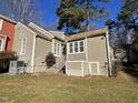 House exterior showcasing tan siding, landscaping, and a storage unit at 5718 Sentinel Dr, Raleigh, NC 27609