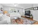 Living room with white couch and colorful rug at 604 Hadley Rd, Raleigh, NC 27610