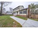 Two-story house with brick and siding, featuring a side view and landscaped lawn at 802 S Sellars Mill Rd, Burlington, NC 27217