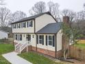 Two-story house with brick and siding, featuring a side view and landscaped lawn at 802 S Sellars Mill Rd, Burlington, NC 27217