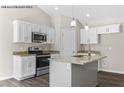 Modern kitchen with white cabinets, granite counters, and an island at 121 Tanglewood Dr # 8-J, Louisburg, NC 27549