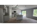 Bright kitchen featuring white cabinets, granite countertops, stainless steel appliances and a center island with a sink at 121 Tanglewood Dr # 8-J, Louisburg, NC 27549