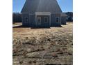 View of the back of the home with a covered porch and neatly trimmed lawn at 123 Surles Landing Way, Benson, NC 27504