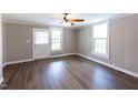 Bright living room with hardwood floors, neutral walls, and large windows at 127 E Ridge St, Rocky Mount, NC 27804