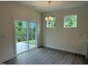 Bright dining area with sliding glass door and modern lighting; views of the outdoors at 129 Stallion Way, Benson, NC 27504