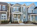 Two-story craftsman style home with light gray siding and a welcoming front porch at 144 Weavers Grove Dr, Chapel Hill, NC 27514