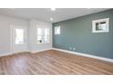 Bright living room with hardwood floors and an accent wall at 144 Weavers Grove Dr, Chapel Hill, NC 27514