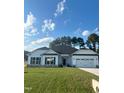 White house with a black roof and two-car garage at 1684 Pecan Drive # 43, Nashville, NC 27856