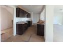 Kitchen area featuring dark cabinets, light countertops, and an open layout at 204 S Beaumont Ave, Burlington, NC 27217