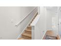 Interior staircase with carpeted steps and a simple handrail at 225 Starlight St, Sanford, NC 27330