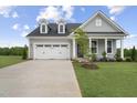 Gray house with white trim, two-car garage, and landscaped lawn at 40 Eagle Crest Ct # Clayton Low Country, Lillington, NC 27546