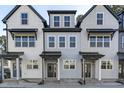 Three-story townhouses with gray and white exterior, covered porches, and stylish design at 4821 Gossamer Ln # 106, Raleigh, NC 27616