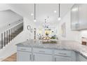 Modern kitchen island with granite countertops, looking toward the living room at 4821 Gossamer Ln # 106, Raleigh, NC 27616