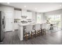 Modern kitchen with white cabinets, granite island, and stainless steel appliances at 508 Freedom Trail Dr, Angier, NC 27592