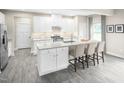 Modern kitchen featuring white cabinets, granite countertops, and an island at 508 Freedom Trail Dr, Willow Springs, NC 27592