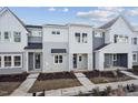 New construction townhomes featuring gray and white siding, covered entries, and well manicured landscaping at 602 Hillfarm Dr, Wake Forest, NC 27587