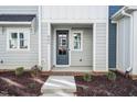 Townhouse entrance with dark gray door and porch at 602 Hillfarm Dr, Wake Forest, NC 27587