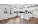 Bright kitchen featuring stainless appliances, an island, tile backsplash, and ample cabinet space at 602 Hillfarm Dr, Wake Forest, NC 27587