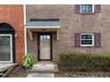 Townhouse entryway with brick exterior and shrubs at 6409 New Market Way, Raleigh, NC 27615