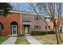 Front view of a brick townhouse with landscaping at 6409 New Market Way, Raleigh, NC 27615