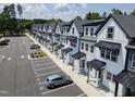 An aerial view of the townhome community featuring rows of modern townhomes and convenient parking at 8610 Brushfoot Way # 106, Raleigh, NC 27616