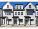 Three-unit townhome building, featuring modern farmhouse style and attractive curb appeal at 8610 Brushfoot Way # 106, Raleigh, NC 27616