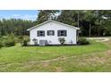 Back view of a renovated white brick ranch home at 889 Burlington Rd, Roxboro, NC 27573