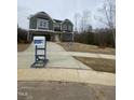 Charming two-story home with stone accents and an attached garage at 9349 Kitchin Farms Way # 463, Wake Forest, NC 27587