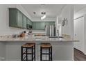 Renovated kitchen with granite countertops and green cabinets at 11 Stone Village, Durham, NC 27704