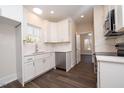 Modern kitchen with white cabinets and marble countertops at 1127 Elmo St, Durham, NC 27701