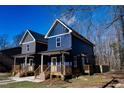 Two story home with navy blue siding and a front yard at 1129 Elmo St, Durham, NC 27701