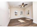 Bright living room with hardwood floors and a ceiling fan at 1129 Elmo St, Durham, NC 27701