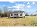 Simple white house with a green lawn and blue sky at 131 Morgan Pkwy, Zebulon, NC 27597