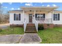 Front porch with brick steps and white railings at 131 Morgan Pkwy, Zebulon, NC 27597