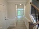 Bright foyer showcases wood floors, wainscoting, and staircase at 137 Stallion Way, Benson, NC 27504