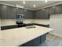 Modern kitchen features an island, granite countertops, and stainless appliances at 137 Stallion Way, Benson, NC 27504