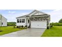 Charming single-Gathering home with stone accents, black shutters, a two-car garage, and manicured lawn at 155 Scenic Rock Dr, Youngsville, NC 27596