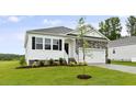 Charming single-Gathering home with stone accents, black shutters, a two-car garage, and manicured lawn at 155 Scenic Rock Dr, Youngsville, NC 27596