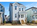 Two-story light blue house with white trim and wooden steps at 1549 Piney Fls Dr, Wendell, NC 27591