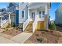 Front entrance with wooden stairs and brick base at 1549 Piney Fls Dr, Wendell, NC 27591