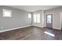 Living room with gray walls, hardwood floors, and a purple door at 1549 Piney Fls Dr, Wendell, NC 27591