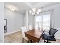 Dining room features hardwood floors, chandelier, and large window at 168 Northwood Dr, Fuquay Varina, NC 27526