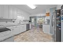 Bright kitchen with white cabinets, granite counters, and tile flooring at 1991 Webster Grove Dr, Mebane, NC 27302