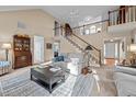 Bright living room with staircase, neutral decor, and comfortable seating area at 1991 Webster Grove Dr, Mebane, NC 27302