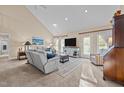 Spacious living room featuring a vaulted ceiling, a large TV, and access to outdoor at 1991 Webster Grove Dr, Mebane, NC 27302