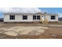 Single-wide manufactured home with brick skirting and wooden steps at 2000 Exum Rd, Nashville, NC 27856