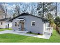 Newly renovated gray brick home with modern updates and a landscaped lawn at 2405 Lane St St, Durham, NC 27707