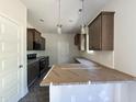 Modern kitchen featuring granite countertops, stainless steel appliances, and stylish pendant lighting at 286 Longbow Dr, Middlesex, NC 27557