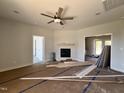 Bright living room with a cozy fireplace and access to other areas of the house at 286 Longbow Dr, Middlesex, NC 27557